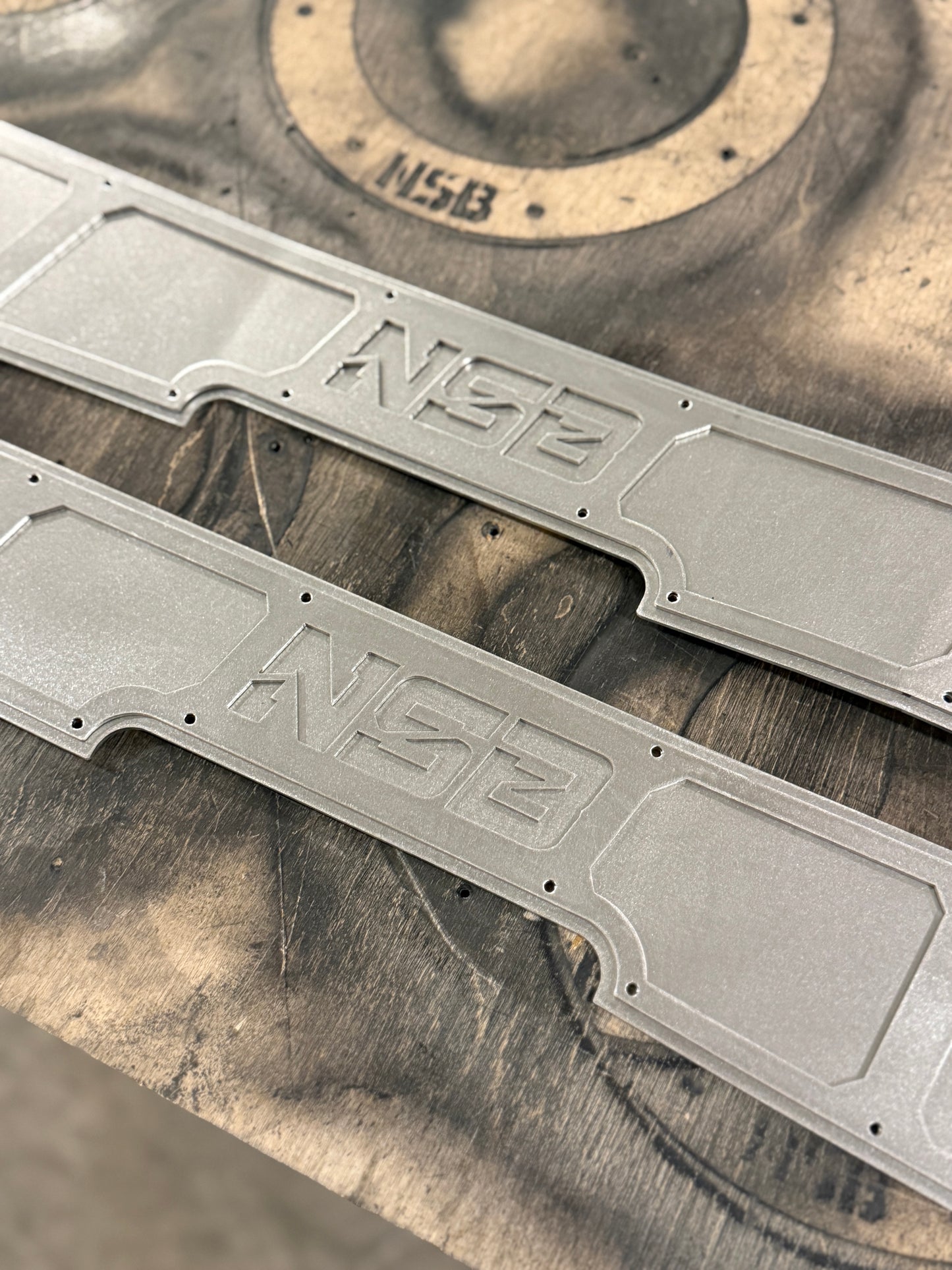 Chevy Silverado GMC Sierra 1500 rear frame plates raw steel closeup on NSB Logo detail