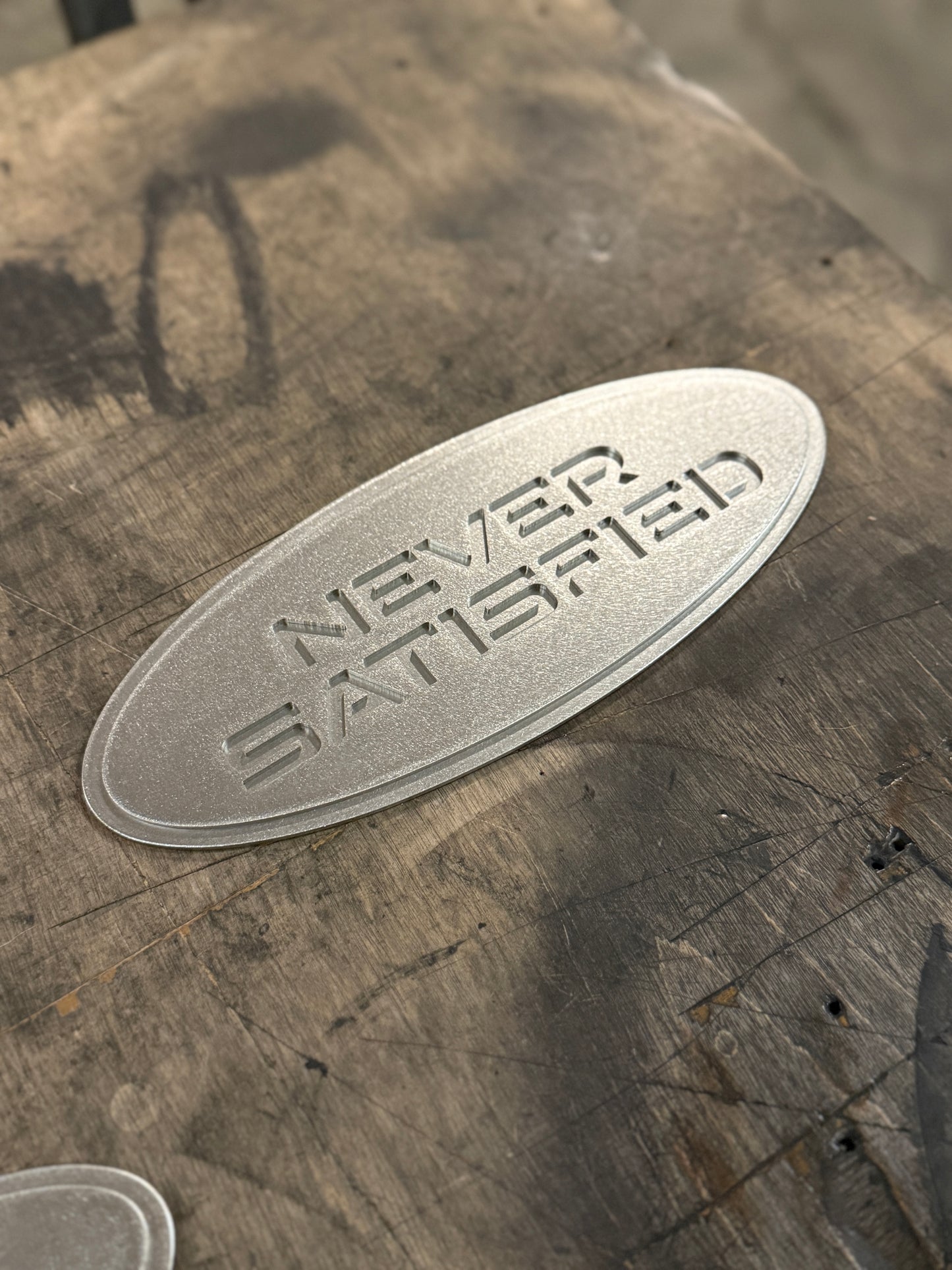 "Never Satisfied" Emblem (Ford 9" Universal Fitment)