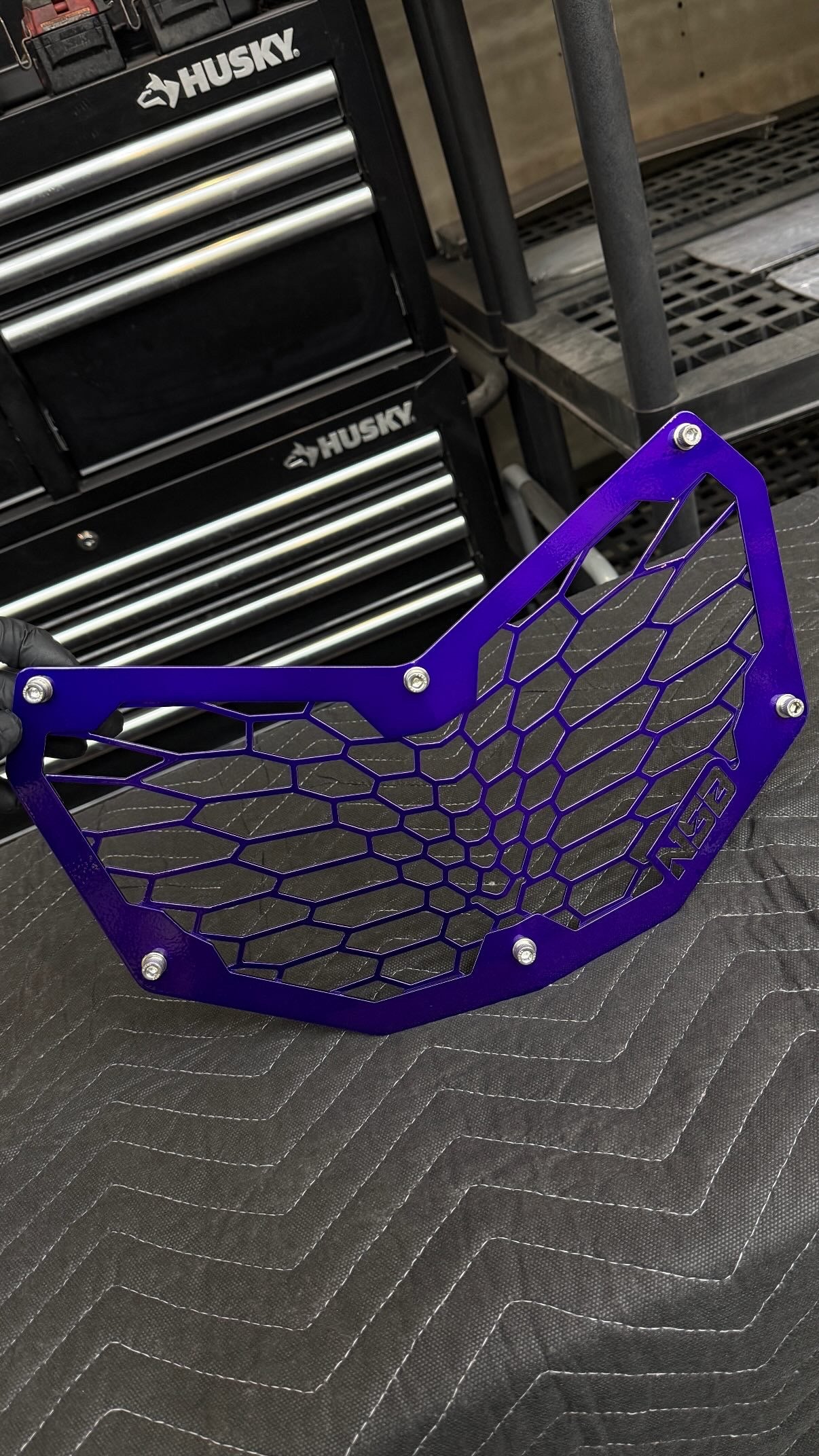 2017-2027 Can-Am Maverick X3 Laser Cut Grille OEM-style gradient design close up with hardware powder coated purple