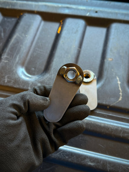 4th gen RAM 1500 Rear Upper Shock Nuts with Tabs Raw steel zoomed in on the back 