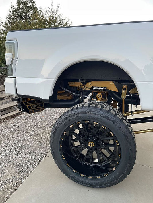 7 inch NSB OVERLAY hexagon Exhaust Tip installed on a lifted truck side view 