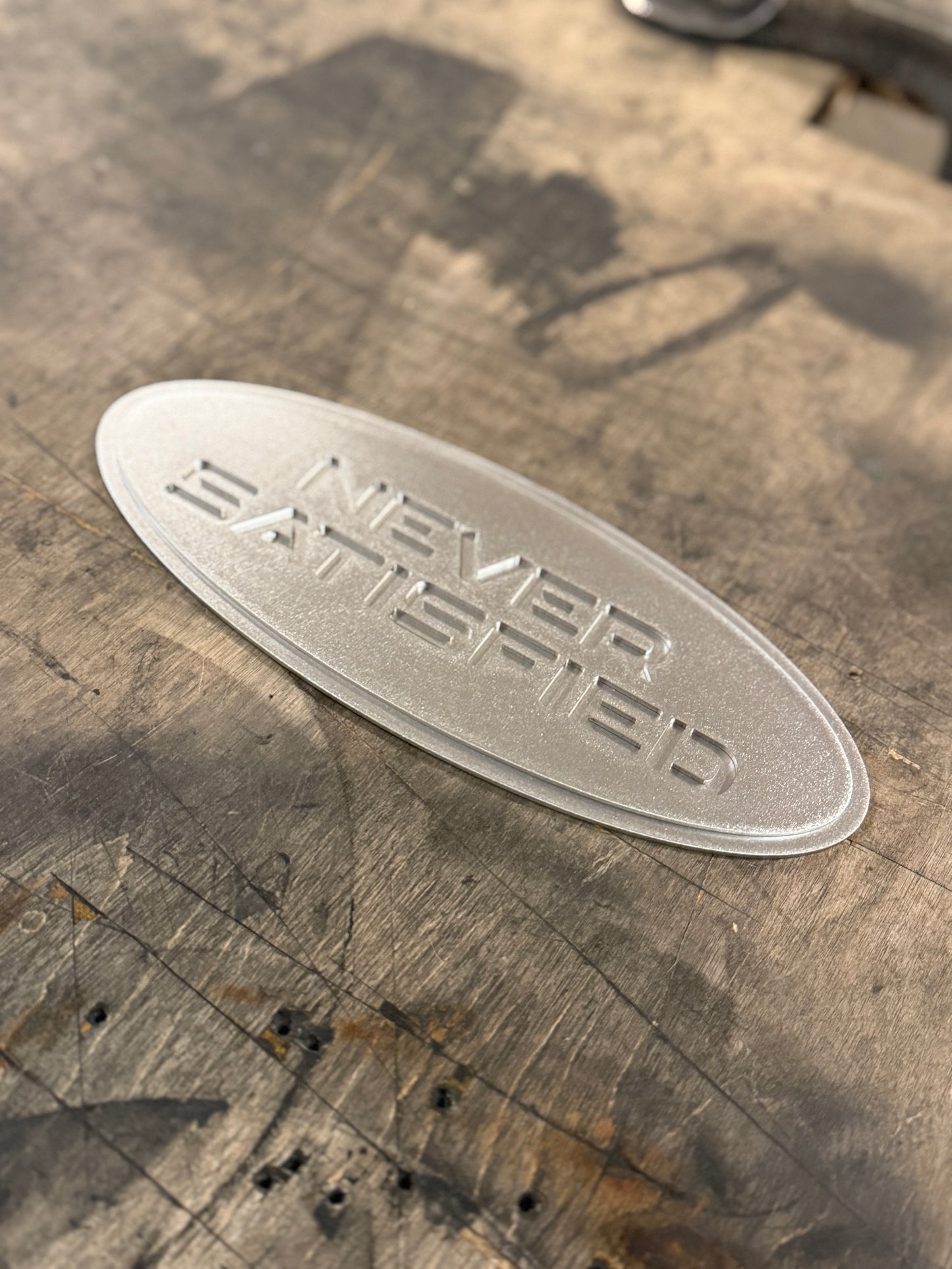 "Never Satisfied" Emblem (Ford 7" Universal Fitment)