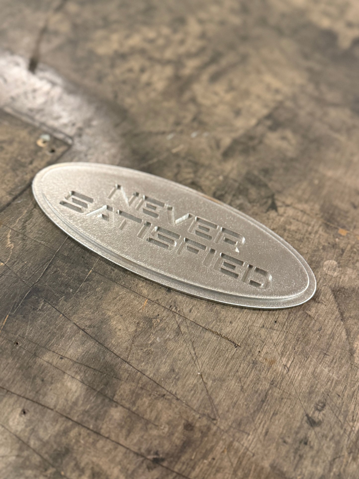 "Never Satisfied" Emblem (Ford 7" Universal Fitment)