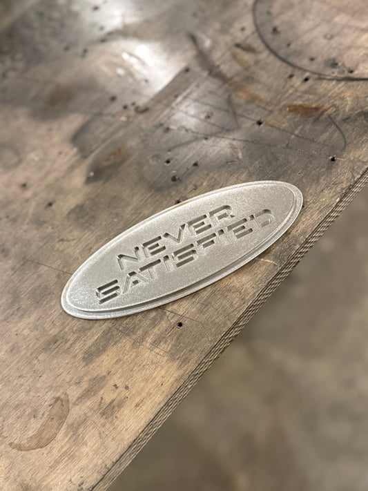 "Never Satisfied" Emblem (Ford 7" Universal Fitment)