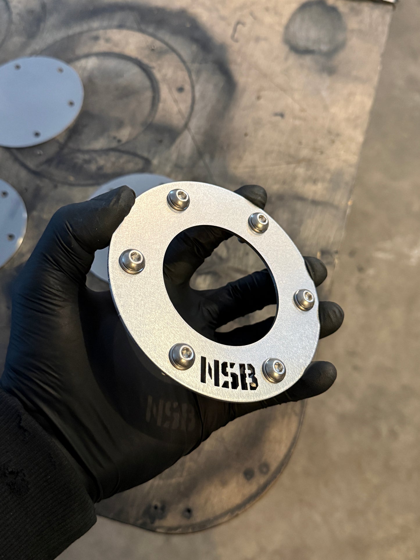 NSB 3 inch exhaust stack ring raw stainless steel with button head bolts close up side view