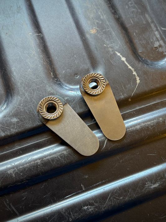 NSB 4th gen RAM 1500 Rear Upper Shock Nuts with Tabs (Pair) Raw steel close up