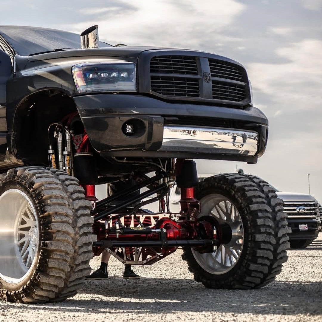 6 inch polished hood stack tallboy mounted on a lifted Dodge Ram side view 
