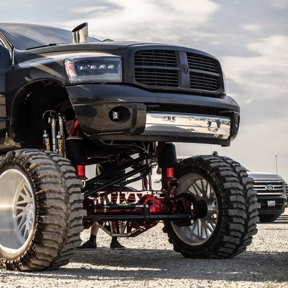 6 inch polished hood stack tallboy mounted on a lifted Dodge Ram side view 