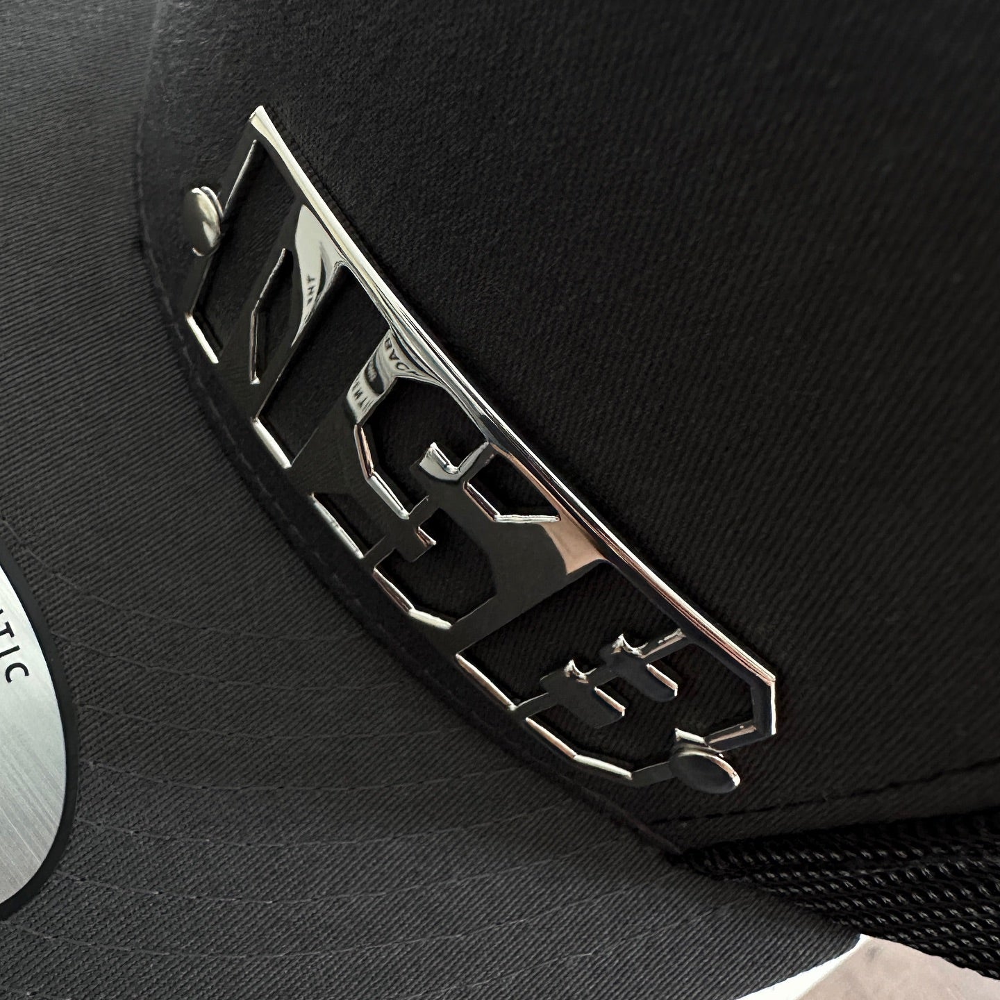 NSB Snapback hat with polished emblem close up detailed view  