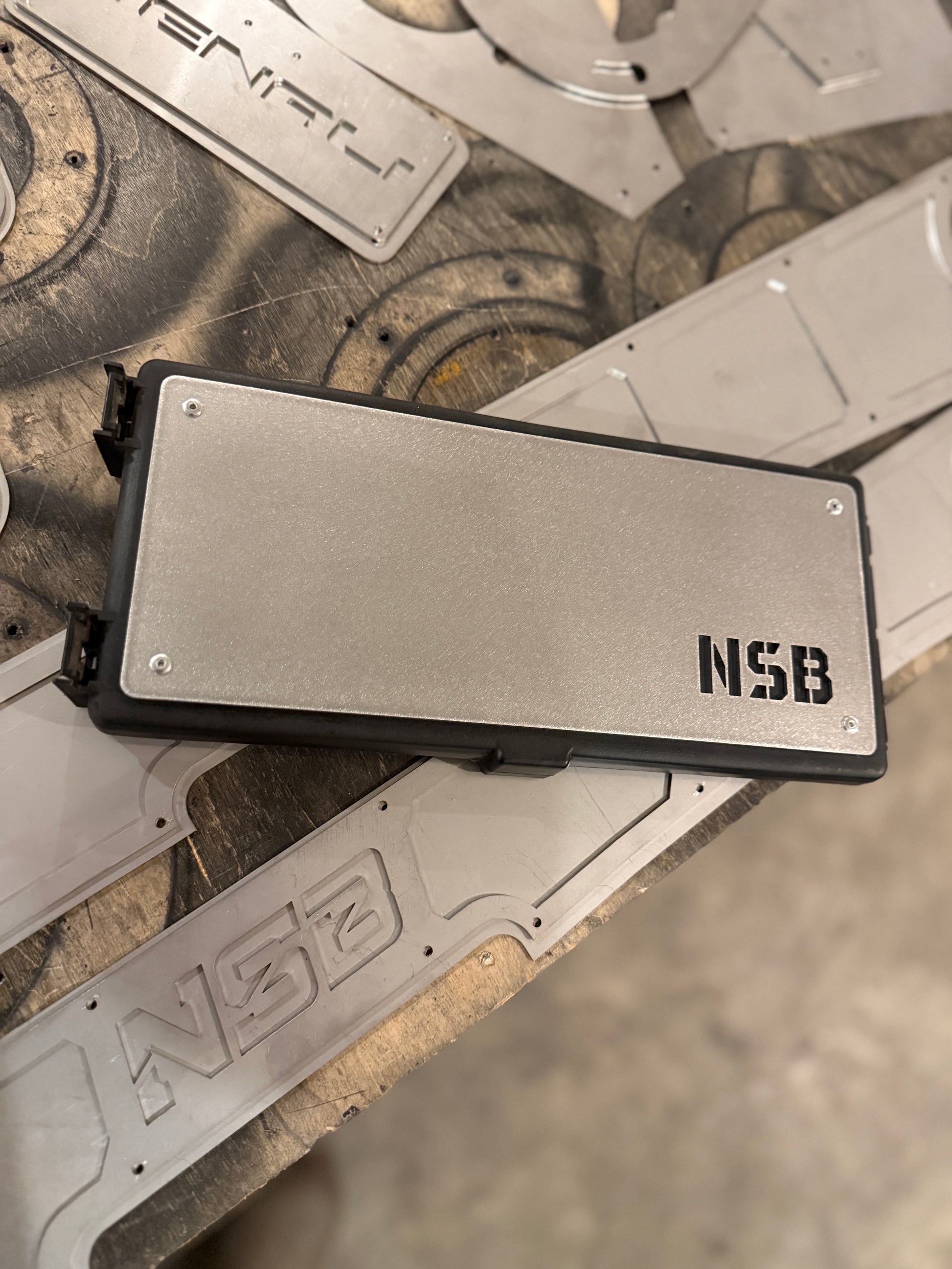 Raw stainless steel fuse box overlay installed on a Dodge Cummins fuse box 