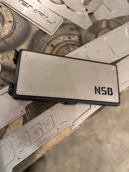 Raw stainless steel fuse box overlay installed on a Dodge Cummins fuse box 